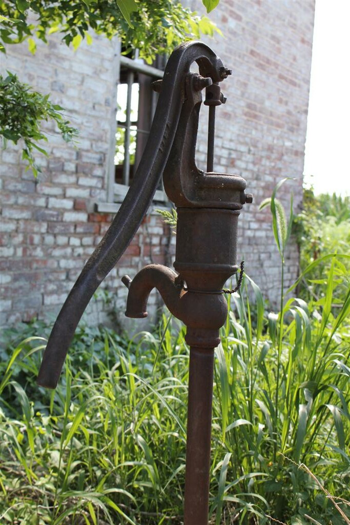 Close-up of a corroded, leaking water pump housing due for replacement