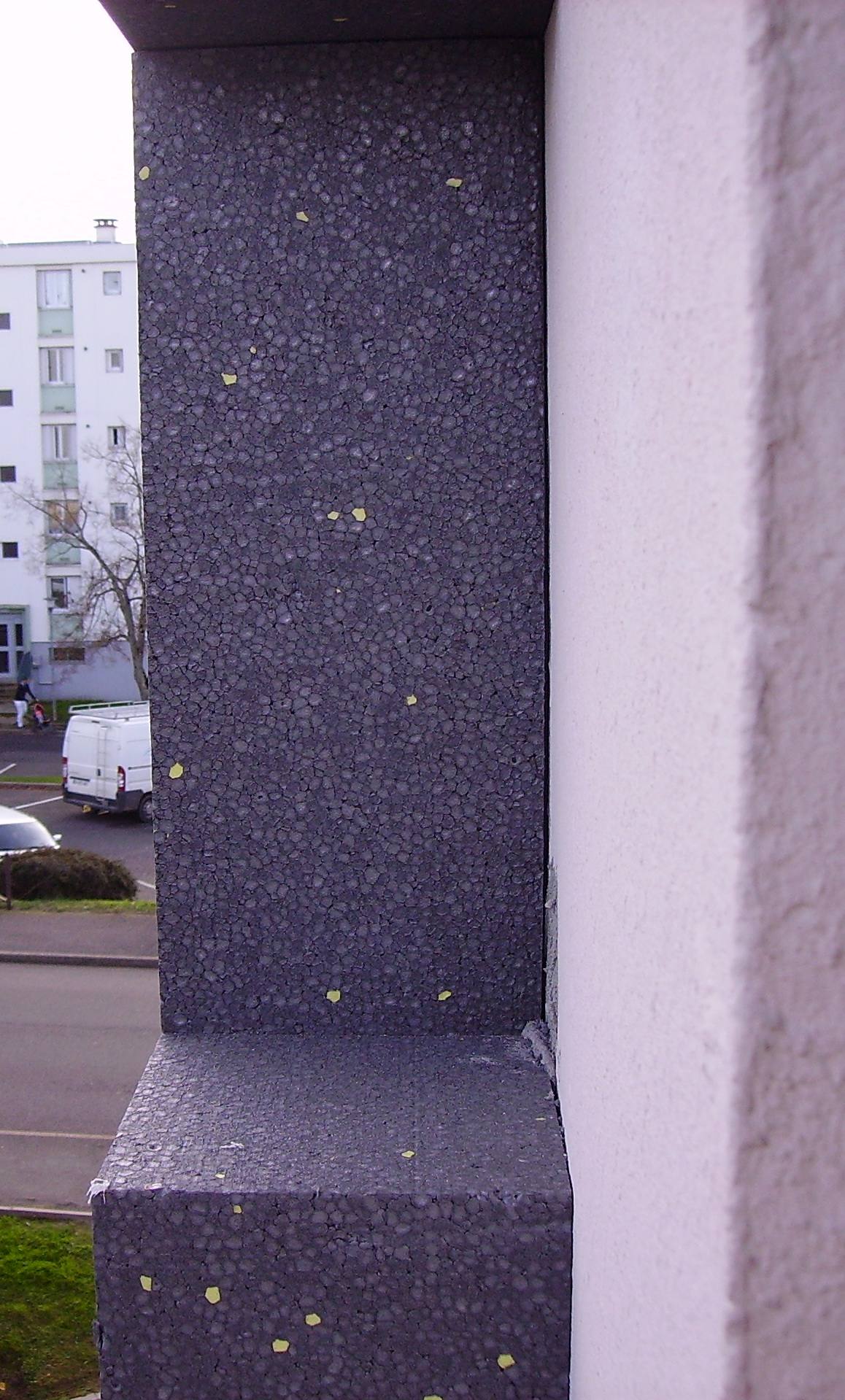 Rigid EPS foam thermal insulation boards being applied to a building exterior wall