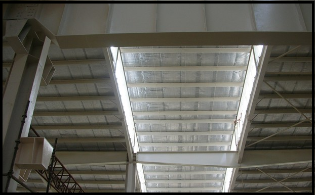 Diagram illustrating how a radiant barrier reflects infrared heat away from a building roof assembly
